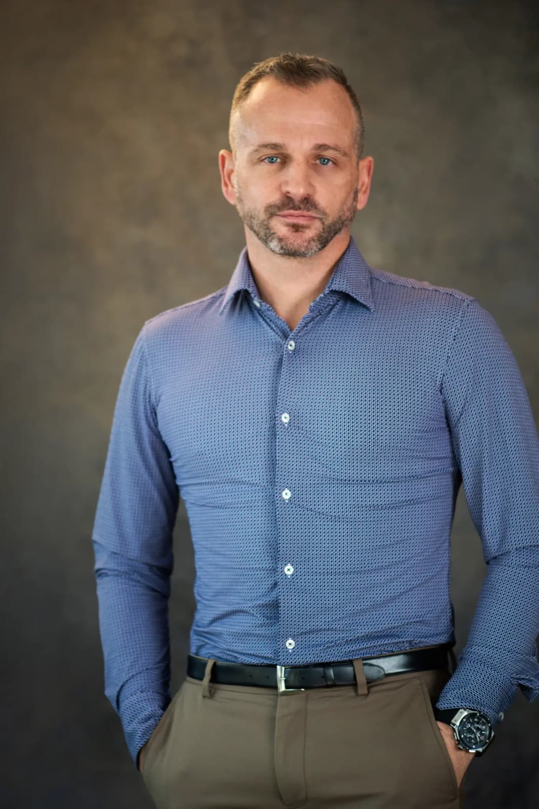 Paul Cohalan standing in a blue patterned shirt