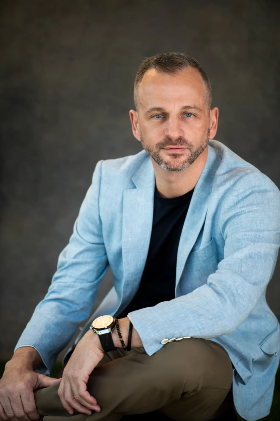 Paul Cohalan seated in a light blue linen blazer